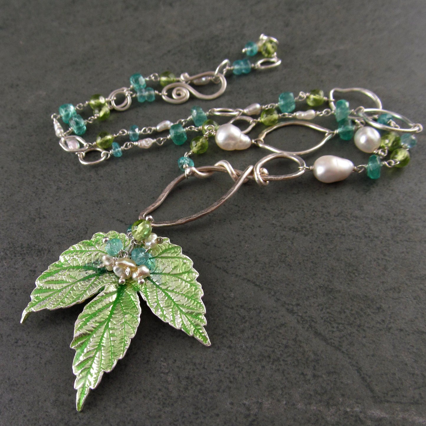 Peridot and apatite necklace with an enameled leaf and pearls in fine and sterling silver