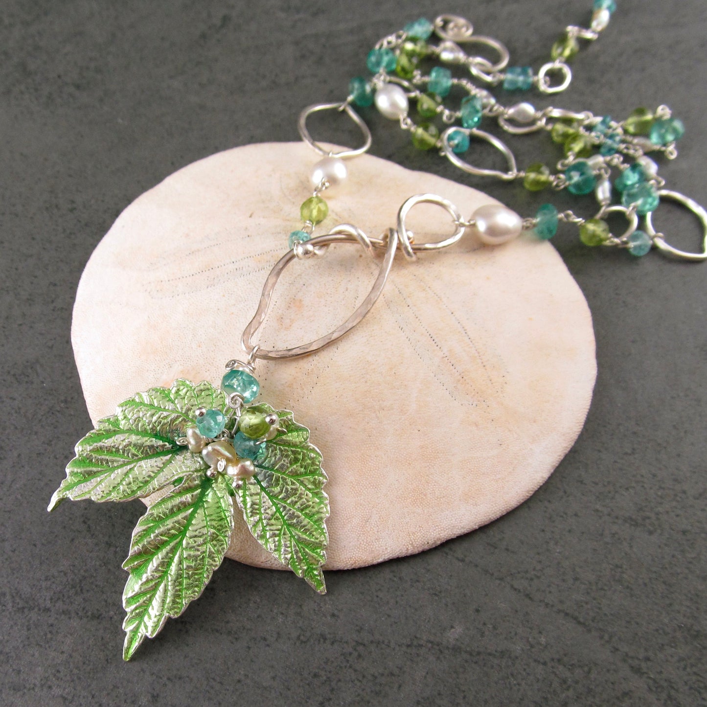 Peridot and apatite necklace with an enameled leaf and pearls in fine and sterling silver