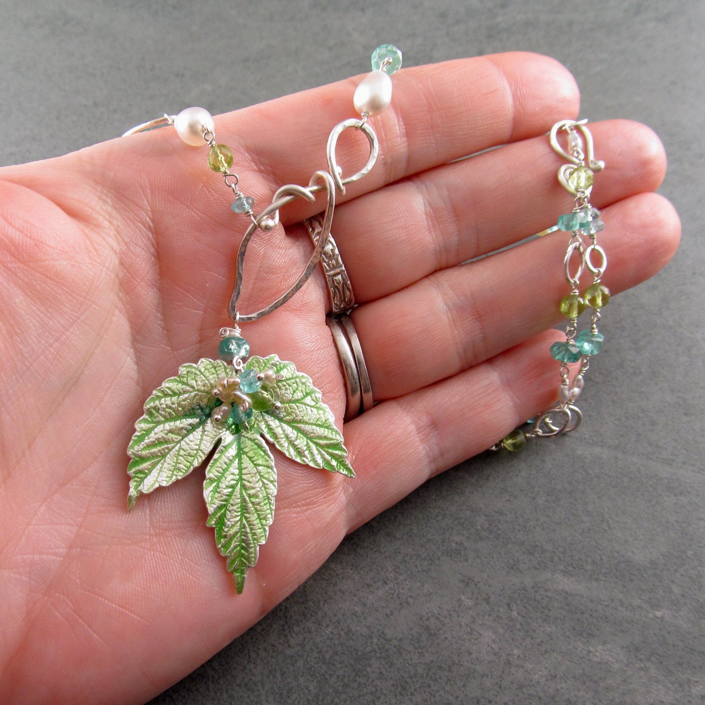 Peridot and apatite necklace with an enameled leaf and pearls in fine and sterling silver