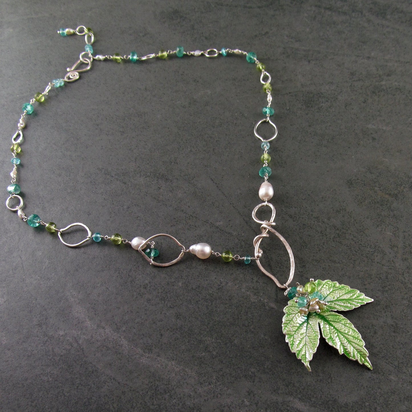 Peridot and apatite necklace with an enameled leaf and pearls in fine and sterling silver