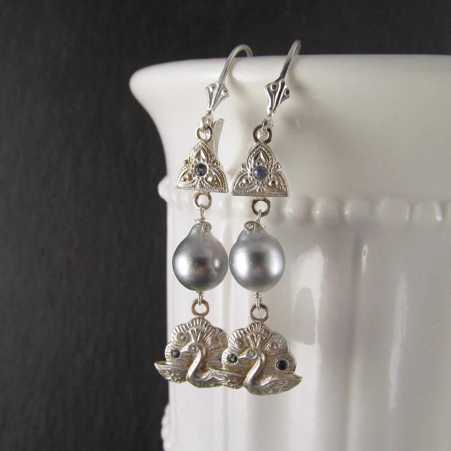 Silver peacock earrings with Tahitian pearls and blue sapphires